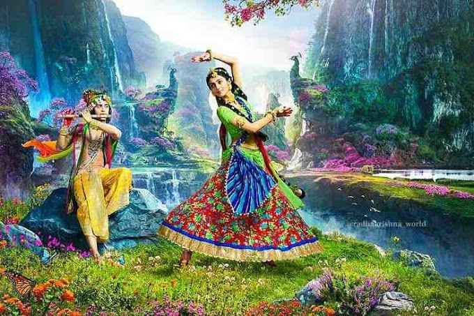 two women dressed in colorful clothing are dancing on the grass with flowers and rocks behind them