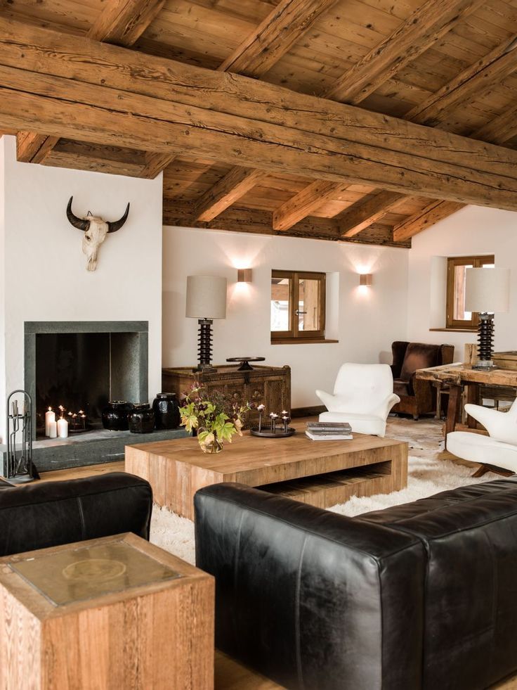 a living room filled with furniture and a cow head mounted to the side of the wall