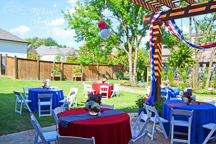 an outdoor party setup with red, white and blue table cloths on the tables