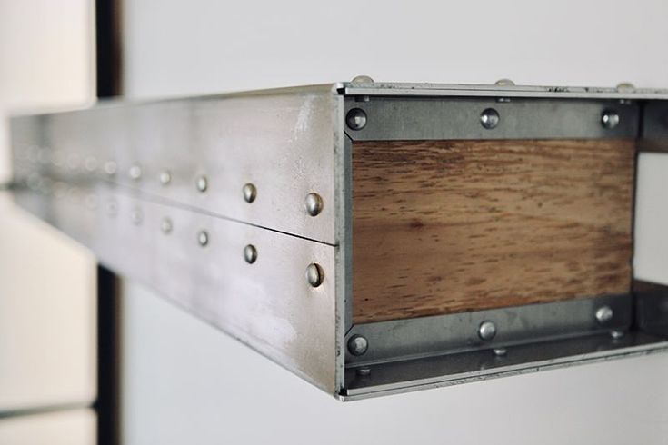 a metal shelf with wood in the middle