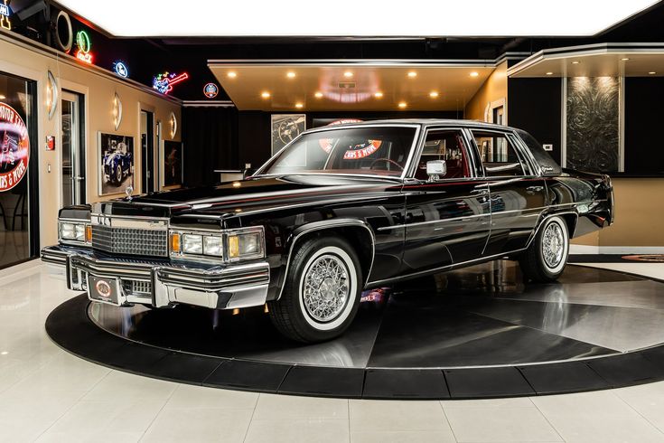 a black car is on display in a showroom