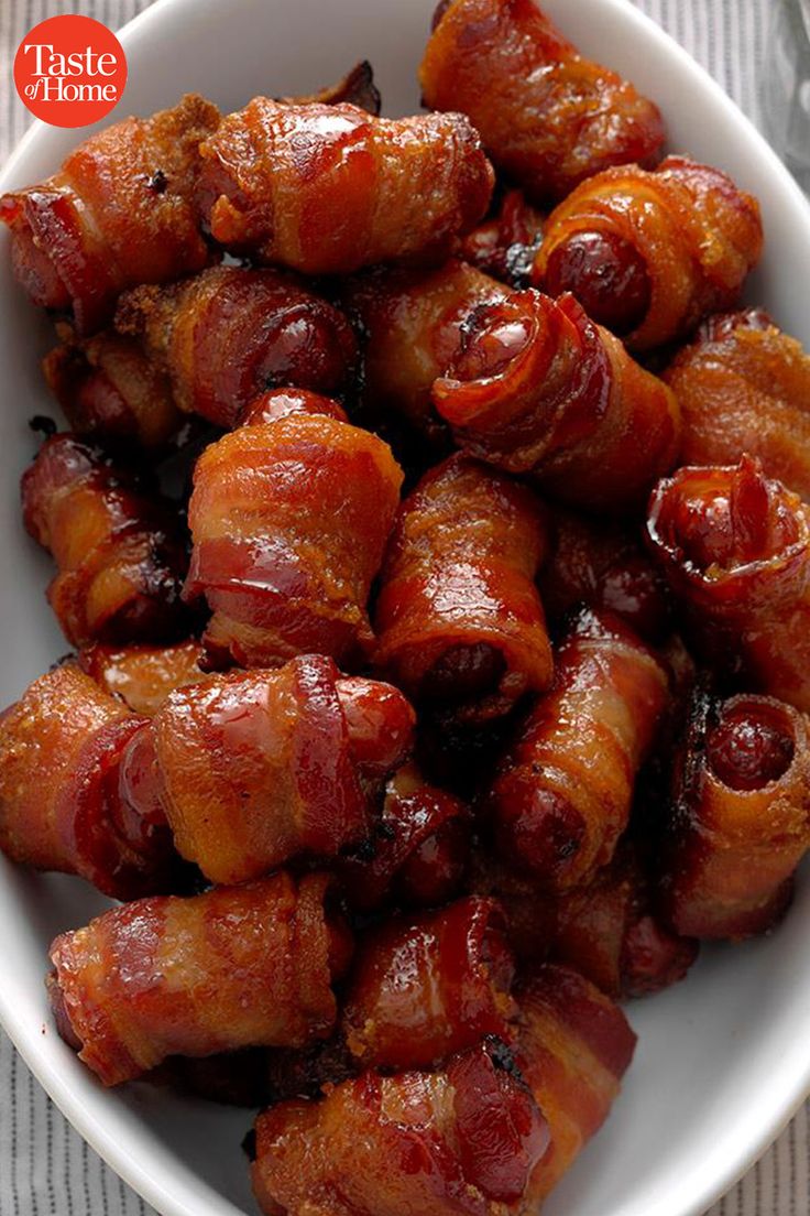 a white bowl filled with bacon wrapped in sauce