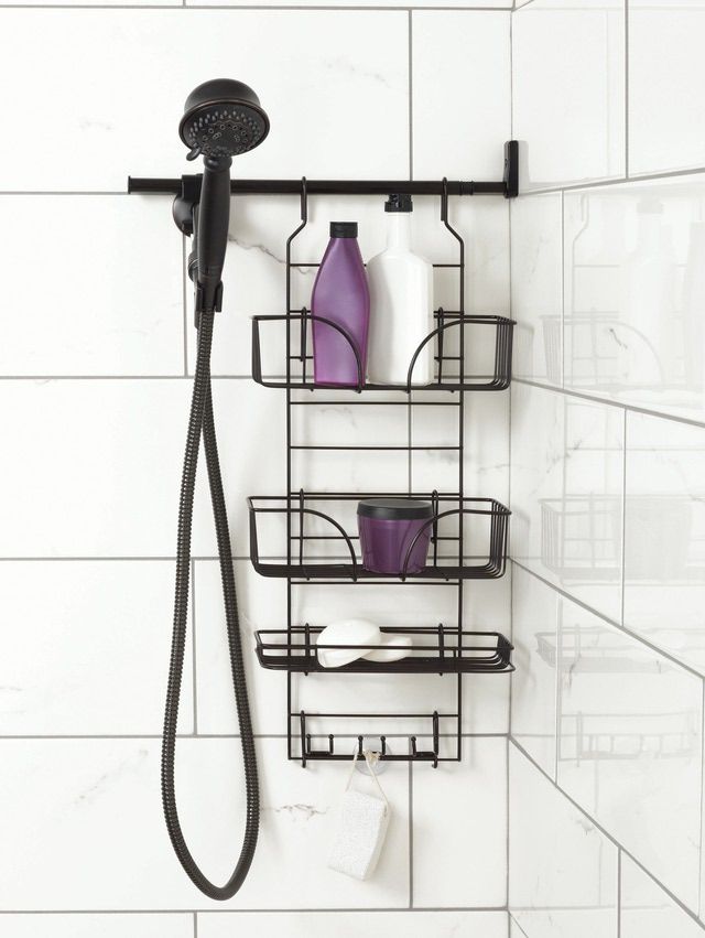 the shower head is mounted to the wall with two shelves for soaps and lotion