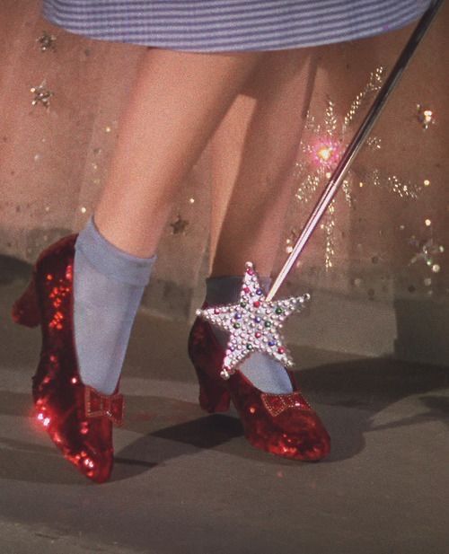 a close up of a person's red shoes with a star on the heel