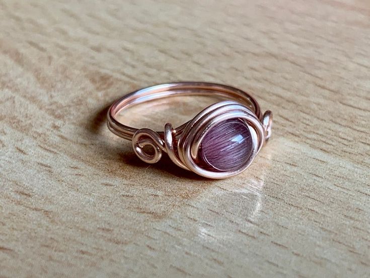 Cats Eye Ring Rose Gold Wire Wrapped Ring in Purple Amethyst | Etsy Jewelry Looks, Cats Eye Ring, Wire Jewelry Rings, Wire Jewelry Designs, Wire Wrapped Ring, Diffuser Jewelry, Wire Work Jewelry, Cats Eye, Homemade Jewelry