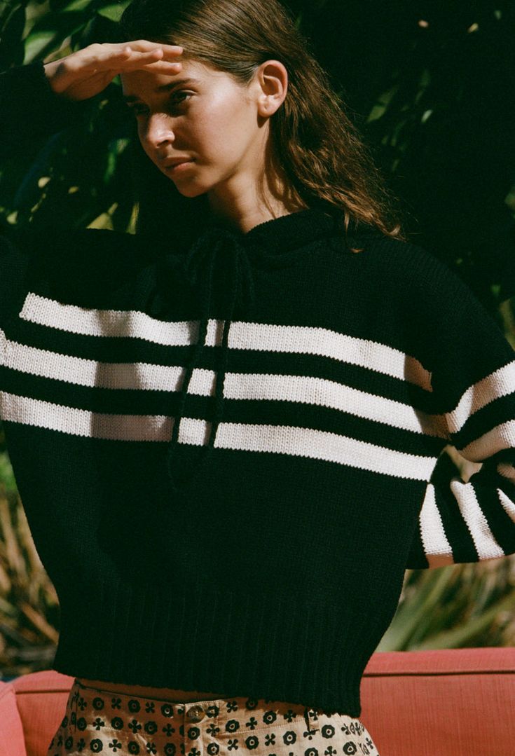 The Tiago Hoodie in black is a merino wool blend drawstring hoodie featuring contrasting white stripes across the body and sleeves. Fit: True to Size. Model wears size small. Sizing: XS-L Materials: 70% Extrafine Merino Wool, 30% Recycled Polyester Casual Black Sweater With Striped Cuffs, Black Casual Sweater With Contrast Stripes, Casual Black Sweater With Contrast Stripes, Sporty Winter Sweater With Contrast Stripes, Striped Sporty Hoodie With Drawstring, Sporty Striped Hoodie With Drawstring, Striped Sweatshirt With Drawstring Hood For Winter, Sporty Fall Sweater With Striped Cuffs, Striped Hooded Sweatshirt For Winter