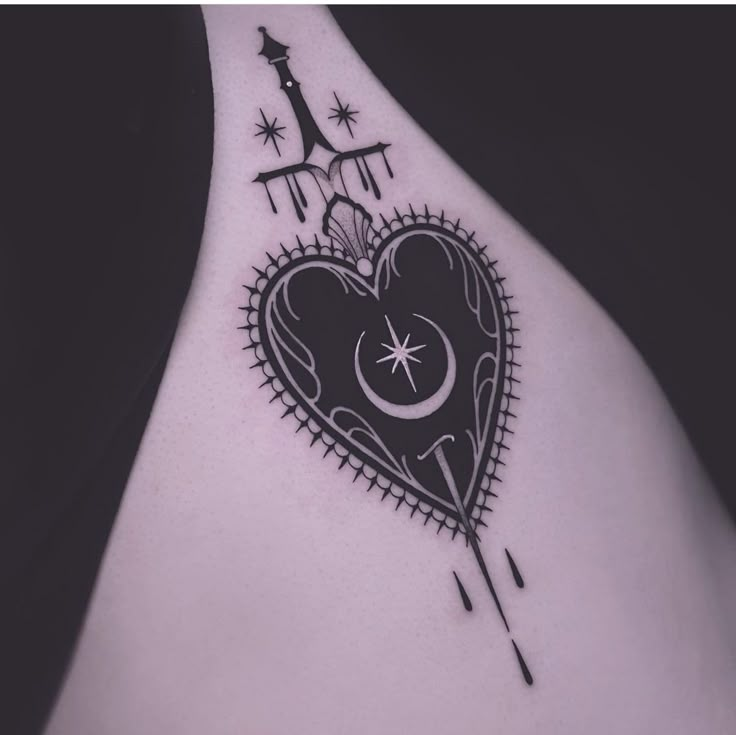 a black and white photo of a heart tattoo