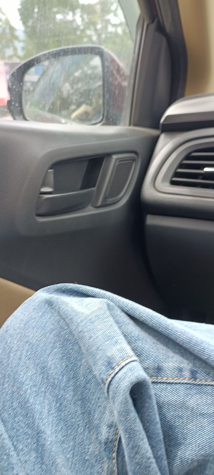 the inside of a car with someone's feet propped up