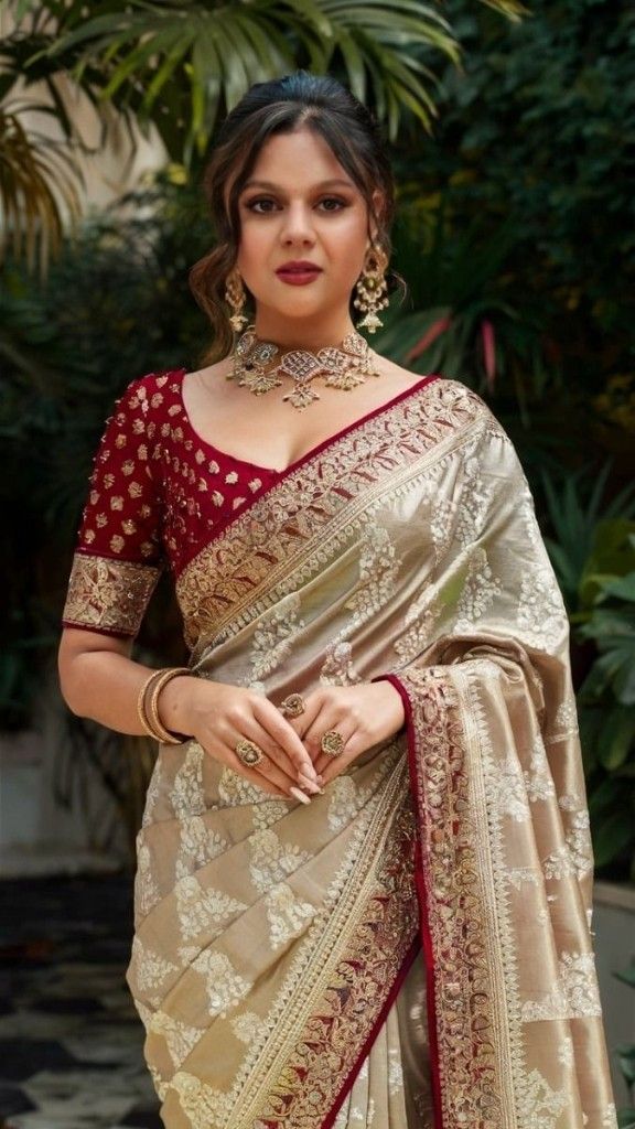 a woman in a white and red sari