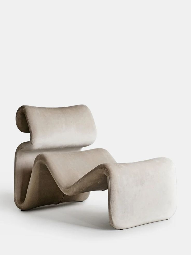 a white chair and ottoman sitting next to each other