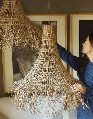 a woman holding up some kind of thing made out of straw