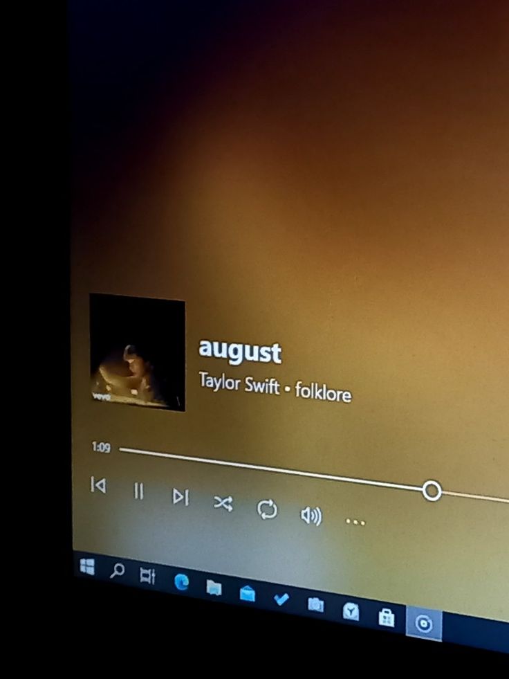 a computer screen with an image of a person on the monitor, and text that reads august taylor swift - folkloree