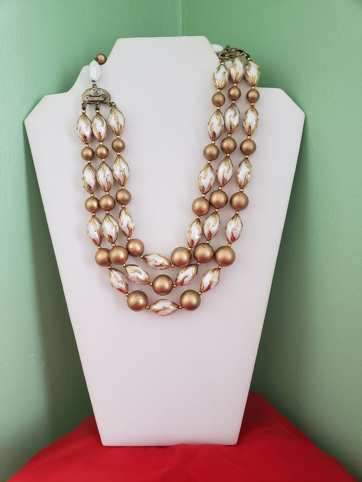 Vintage Deauville  Triple strand gold and faux pearl necklace, statement necklace Vintage 1950s to 1960s Gold Tone Triple Strand Faux Pearl Retro Wedding/Casual Dressy  Signed Deauville Measures:   Choker  18" incld extension Each Strand Length                                    6 "                                    6 1/2 "                                    7 " Doubled    9" It is secured using Hook Clasp.  It would look great with a pair of jeans, white blouse and pumps/boots... But you be the judge ... thanks for looking ! Necklace Art Deco, Wedding Casual, Necklace Art, Casual Dressy, Retro Wedding, Necklace Statement, Faux Pearl Necklace, Boot Pumps, Hook Clasp