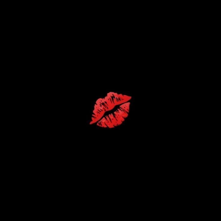 a red lipstick on a black background with the word love written in it's upper right corner