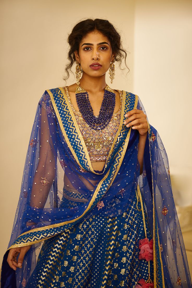 Editor's Note This set features a zardozi embroidered royal blue lehenga with blouse and dupatta. Color: Royal Blue Fabric: Silk Jaquard And Chanderi Jaquard Embroidery Details: Zardozi Care: Dry Clean Only Customize Your Outfit Can't find the size you're looking for? No stress. Just select the size "Custom" while adding the item to your cart. We will follow up with you for your body measurements. To request a color or design customizations, please contact our customer care by using our "Ask us Royal Blue Lehenga, Lehenga With Blouse, Royal Blue Fabric, Blouse Yoke, Personal Shopping Service, Blue Lehenga, Embroidered Lehenga, Casual Tunics, Indian Ethnic Wear