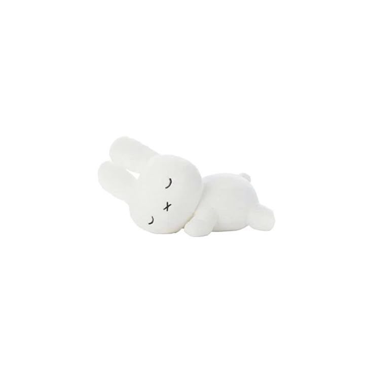 a white stuffed animal laying on its side