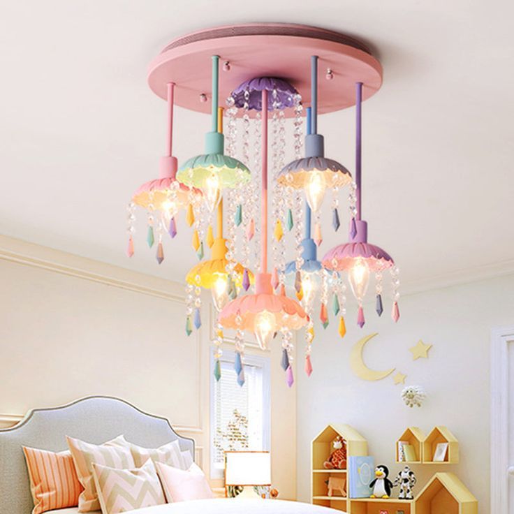 a chandelier hanging from the ceiling in a child's room with colorful lights