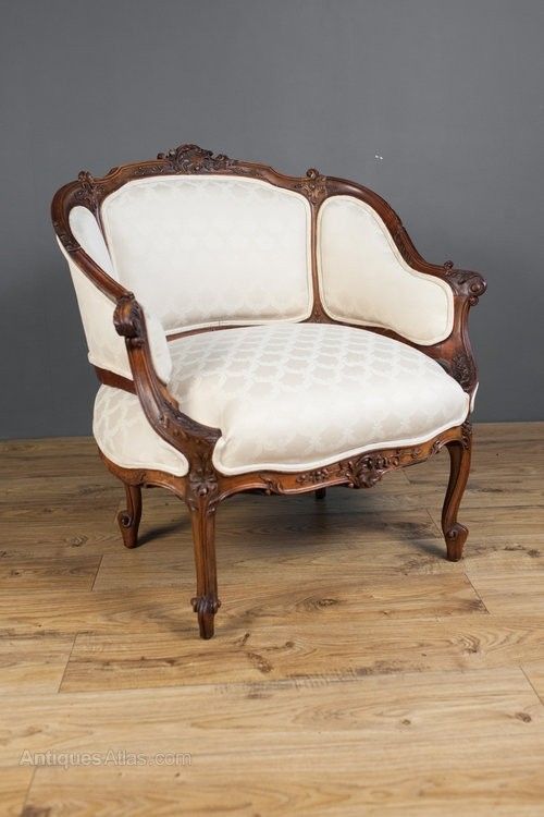 an old wooden chair sitting on top of a hard wood floor