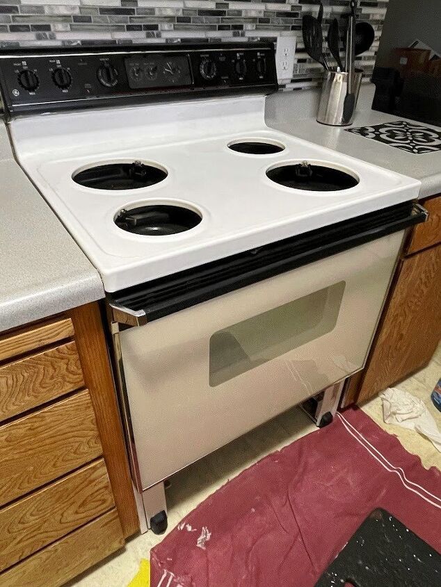 a stove top oven sitting inside of a kitchen