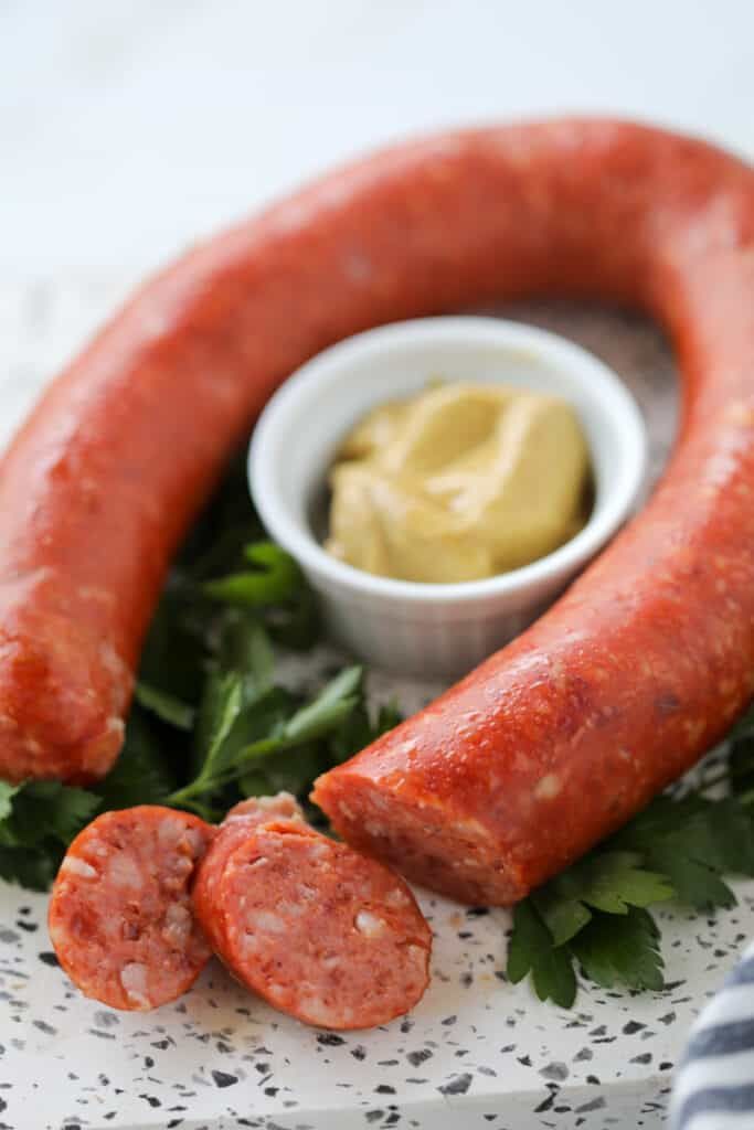 two sausages on a plate with mustard and ketchup next to each other