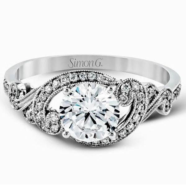 a white gold engagement ring with an intricate design