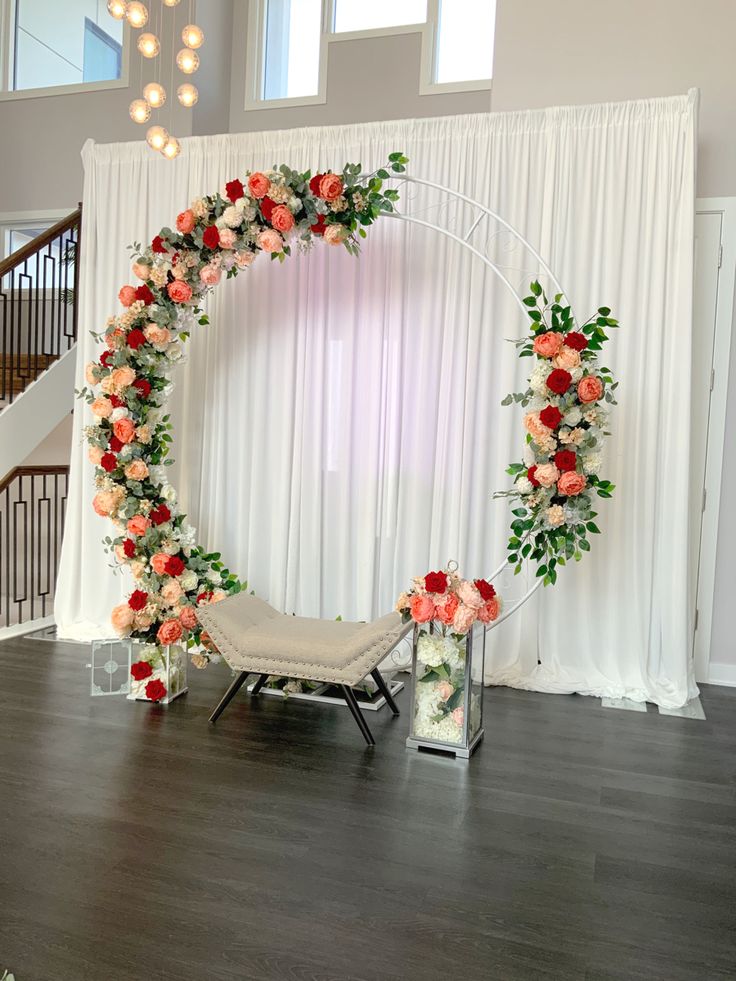 an arch decorated with flowers and greenery