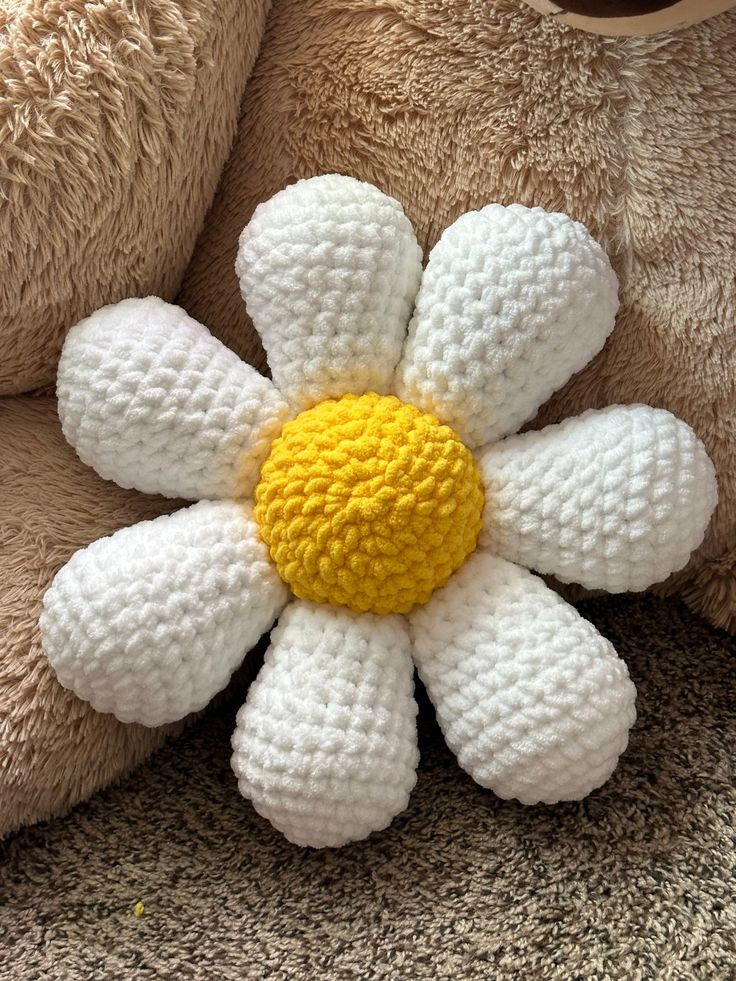 a crocheted flower on the back of a teddy bear