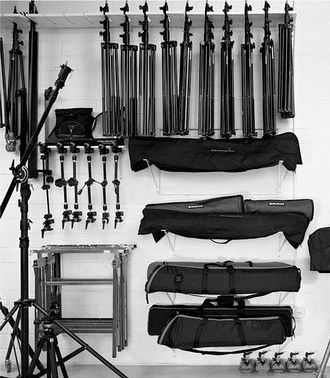 there are many musical instruments on the wall and behind them is a camera set up