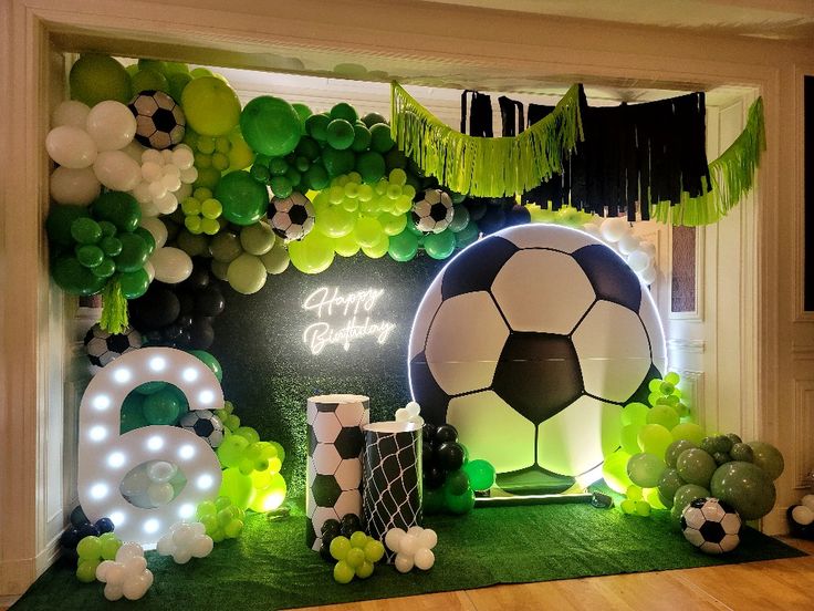 a soccer themed birthday party with balloons and decorations