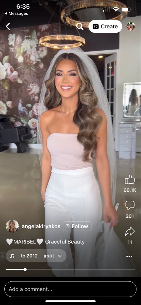 a woman wearing a wedding dress and veil on her face with an instagramr