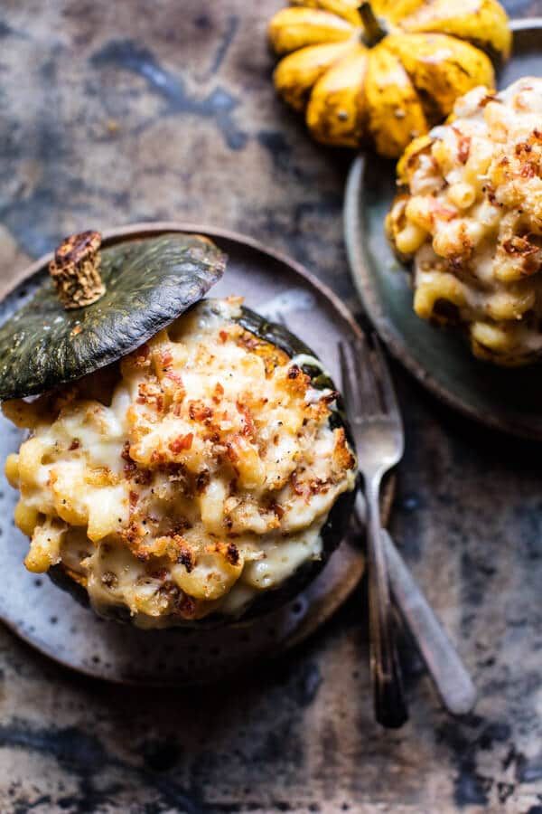 two plates filled with macaroni and cheese on top of a table next to bananas