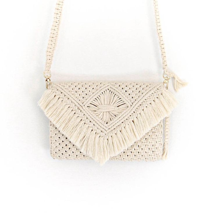 This 100% hand-crafted macrame purse features a removable strap, allowing it to be used as a clutch. Its white color exudes a natural, textured aesthetic that is sure to enliven any look. One of our favorites, we are sure it will be yours also! Beige Bohemian Clutch Shoulder Bag, Bohemian Beige Clutch Shoulder Bag, Beige Macrame Shoulder Bag, Beige Rectangular Shoulder Bag With Macrame, Chic Macrame Rectangular Shoulder Bag, Beige Macrame Rectangular Shoulder Bag, Chic Rectangular Macrame Shoulder Bag, Cream Macrame Shoulder Bag For Daily Use, Beige Rectangular Macrame Shoulder Bag