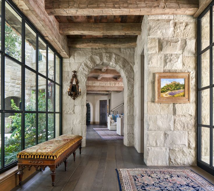 the hallway is lined with windows and stone walls