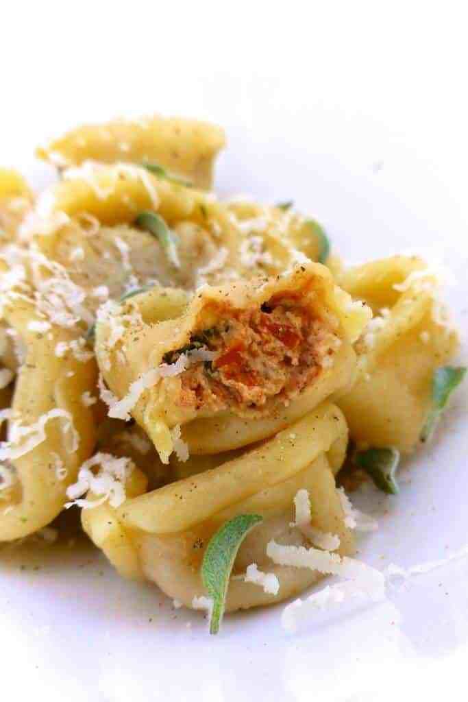 pasta with meat and parmesan cheese on a white plate