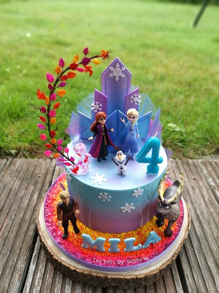 a frozen princess birthday cake on a wooden table