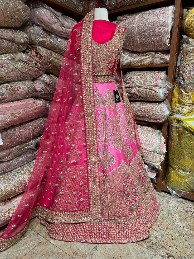 1. Pink ombre raw-silk lehenga features intricate details with multi-color resham, zardozi, sequins, and crystal embroidery. 2. Complete the ensemble with the included hot pink unstitched blouse and Net dupatta 3. Ready to ship ! Pink Raw Silk Anarkali Set For Navratri, Embellished Pink Silk Traditional Wear, Pink Embellished Silk Traditional Wear, Pink Silk Embellished Sets, Embellished Pink Silk Sets, Pink Embellished Silk Sets, Pink Raw Silk Sharara For Navratri, Pink Tissue Silk Dress For Navratri, Festive Pink Lehenga In Tissue Silk