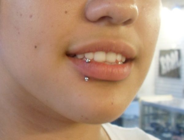 a close up of a person's nose with piercing on it