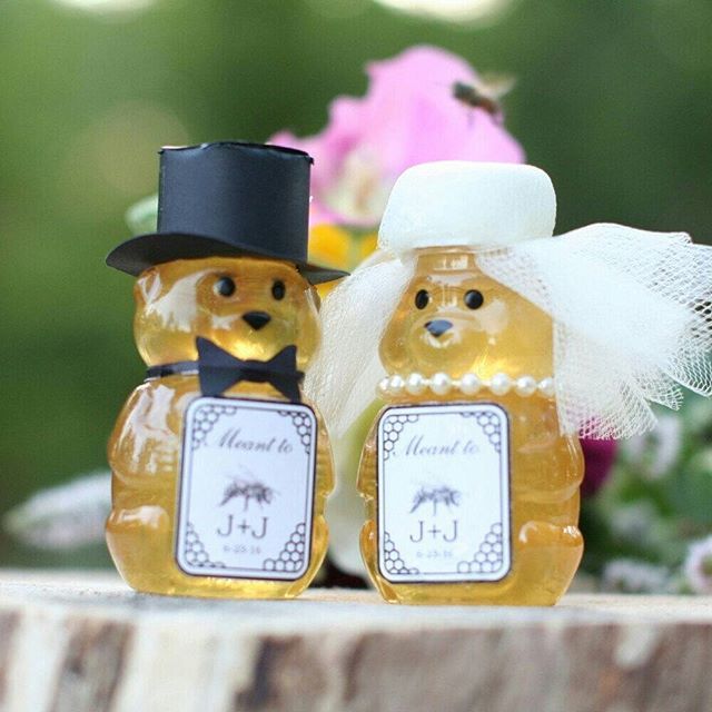 two honey jars with wedding decorations on them