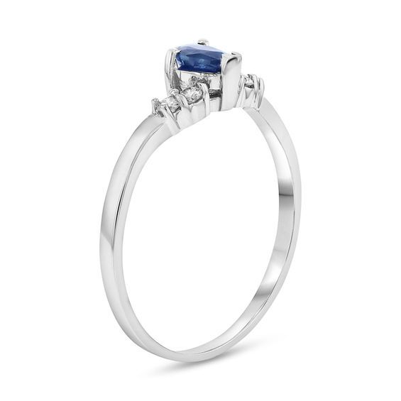 Smart and modern, this gemstone and diamond ring makes a simply chic statement of fashion. Created in 14K white gold, this dainty style features a 5.0 x 3.0mm pear-shaped bright blue sapphire cleverly set between pairs of sparkling petite diamonds along a chevron-shaped shank. Radiant with 1/15 ct. t.w. of diamonds and a brilliant buffed luster, this design is a charming anytime look. Fine Jewelry Diamond Birthstone Ring In White Gold, White Gold Diamond Birthstone Ring Fine Jewelry, Elegant Stackable Diamond Rings With Accent Stones, Elegant Diamond Stackable Rings With Accent Stones, Modern White Gold Diamond Birthstone Ring, Modern White Gold Birthstone Ring With Accent Stones, Modern Sapphire Diamond Rings, Modern Sapphire Diamond Ring With Birthstone, Elegant Diamond Birthstone Ring Baguette Cut