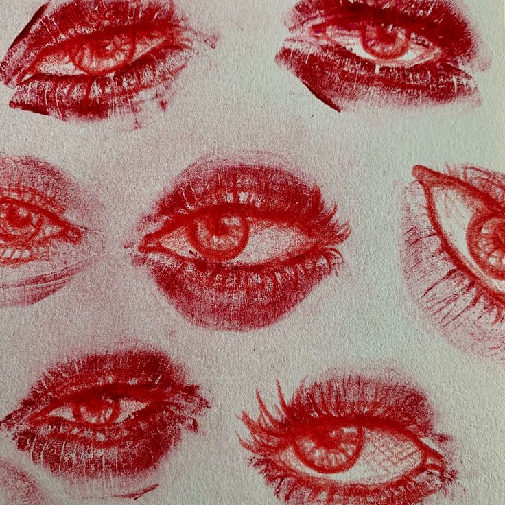 an image of different types of eyes drawn in red pencil on white paper with watermark