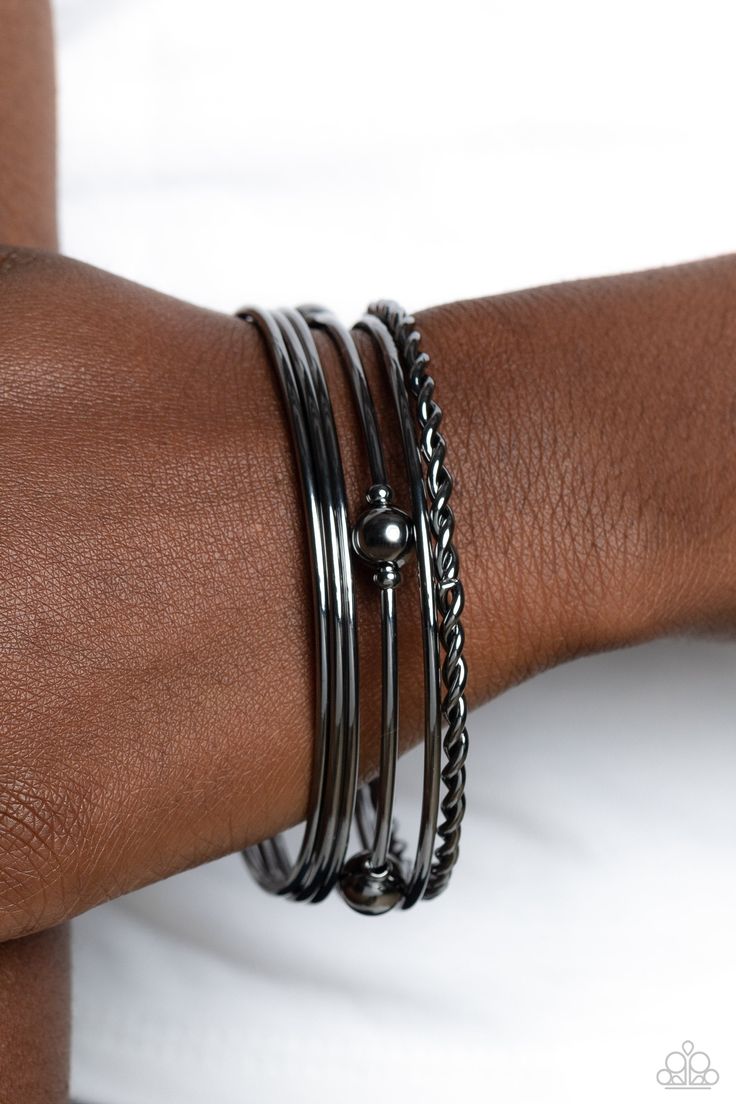 A collision of sleek gunmetal bangles slides up and down the wrist for an industrially-layered look. One thin bangle features a braided texture, while another bangle features static gunmetal accents and spheres for a subtle, eye-catching artisan touch. Sold as one set of six bracelets. Black Bangle, Inspired Aesthetic, Brass Bangle, Brass Bracelet, Lost And Found, Black Bracelets, Paparazzi Accessories, Brass Accents, Paparazzi Jewelry