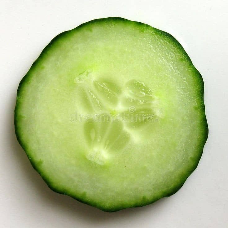 a cucumber cut in half on a white surface stock images and royalty photos