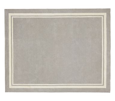 a gray rug with white border