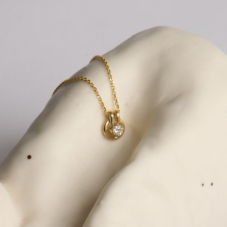 A fine chain leads to a circular gold pendant, with a diamond at the center. Inspired by the gold buttons that decorated suits in the 80s and 90s, we wanted to bring this moment back through one of our necklaces. Although overlooked often, buttons have played an integral role in fashion, whether advancing in practicality or as ornate details. We made sure that this piece was able to move along the chain like buttons do up and set free. If ordered in rose gold, the chain will be our Rollo chain. Letter Bracelet, Set Free, Pendant Rings, Bracelet Collection, Girls Earrings, Diamond Bracelets, Gold Buttons, Signet Ring, Long Earrings