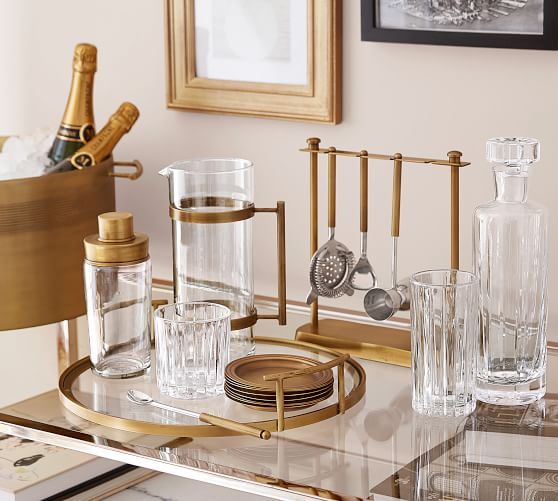 a glass table topped with bottles and glasses