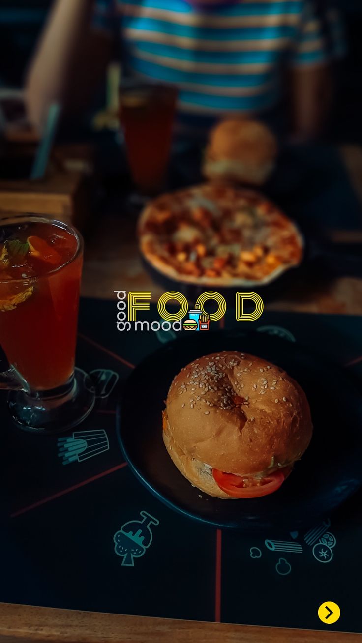 a sandwich and drink sitting on a table with the word food written in front of it