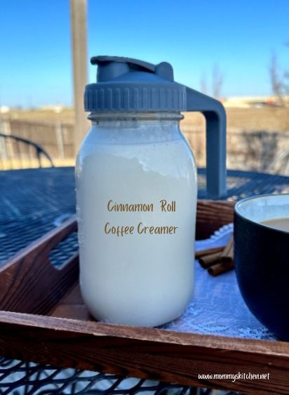 a bottle of coffee creamer sitting on top of a wooden tray