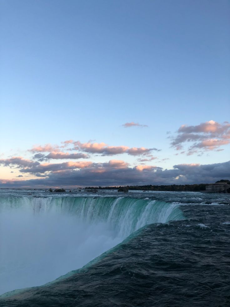 the water is very high and it looks like waves are coming out of the falls