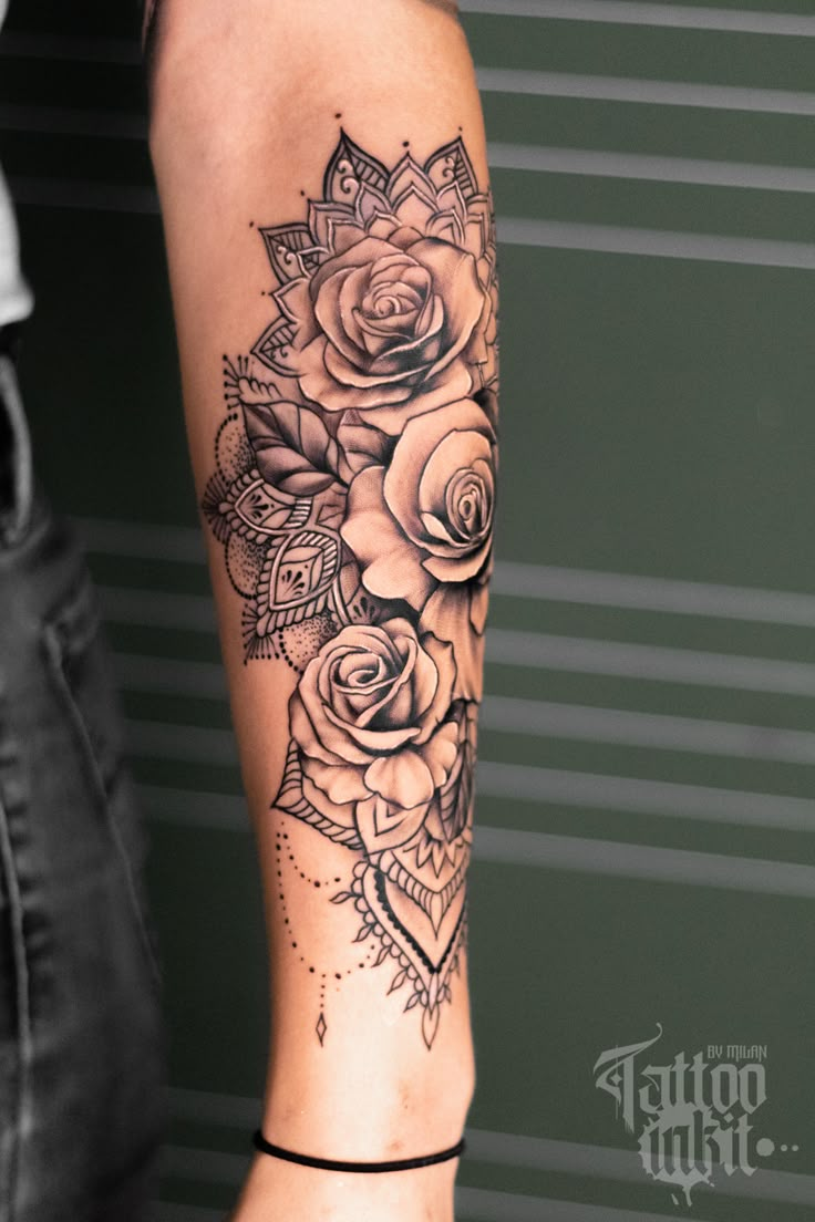 a woman's arm with roses on it