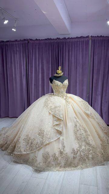 a dress on display in front of purple curtains